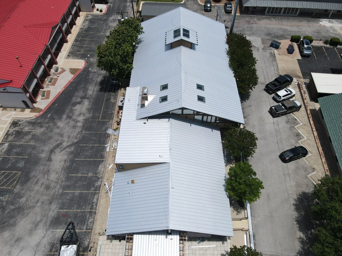 Aerial view of a finished standing-seam metal roof on a commercial building