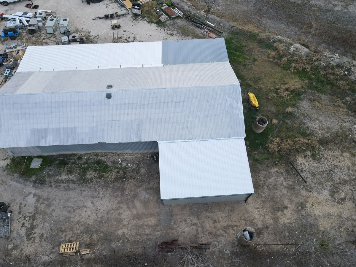 Aerial view of a finished standing-seam metal roof on a warehouse building