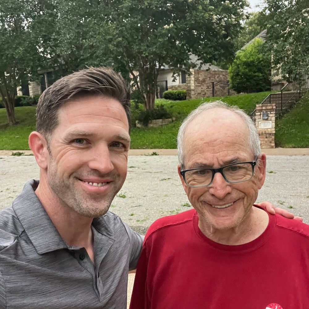 Daniel with a homeowner in the driveway after a job