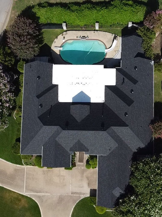 Aerial view of a dark designer roof beside a pool