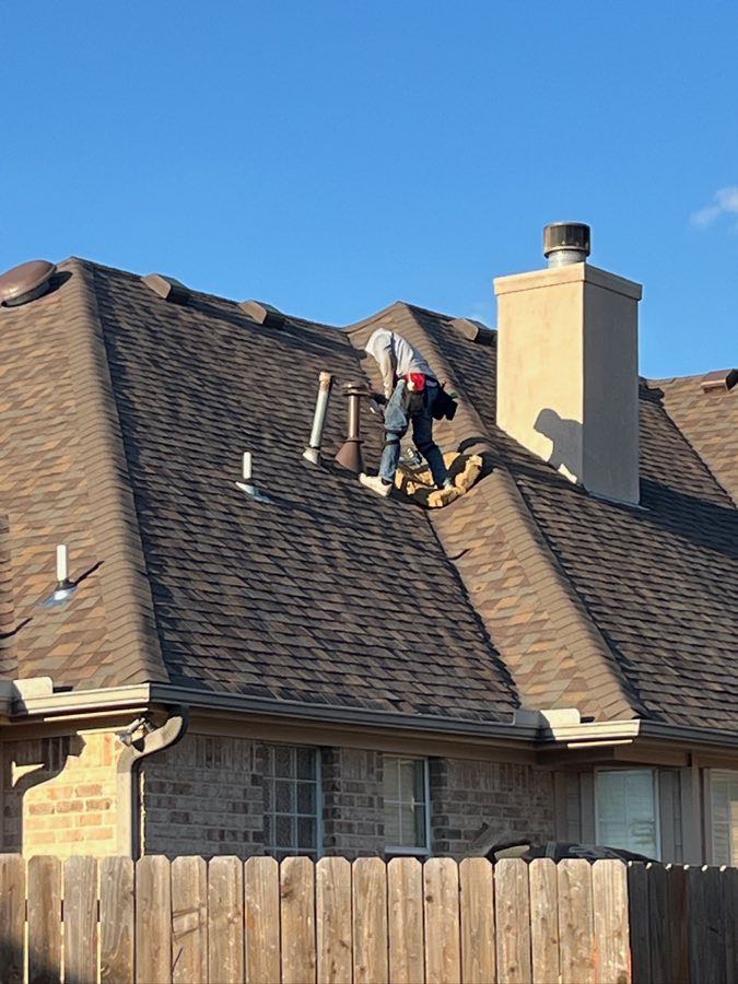 Roofing professional inspecting a residential roof field